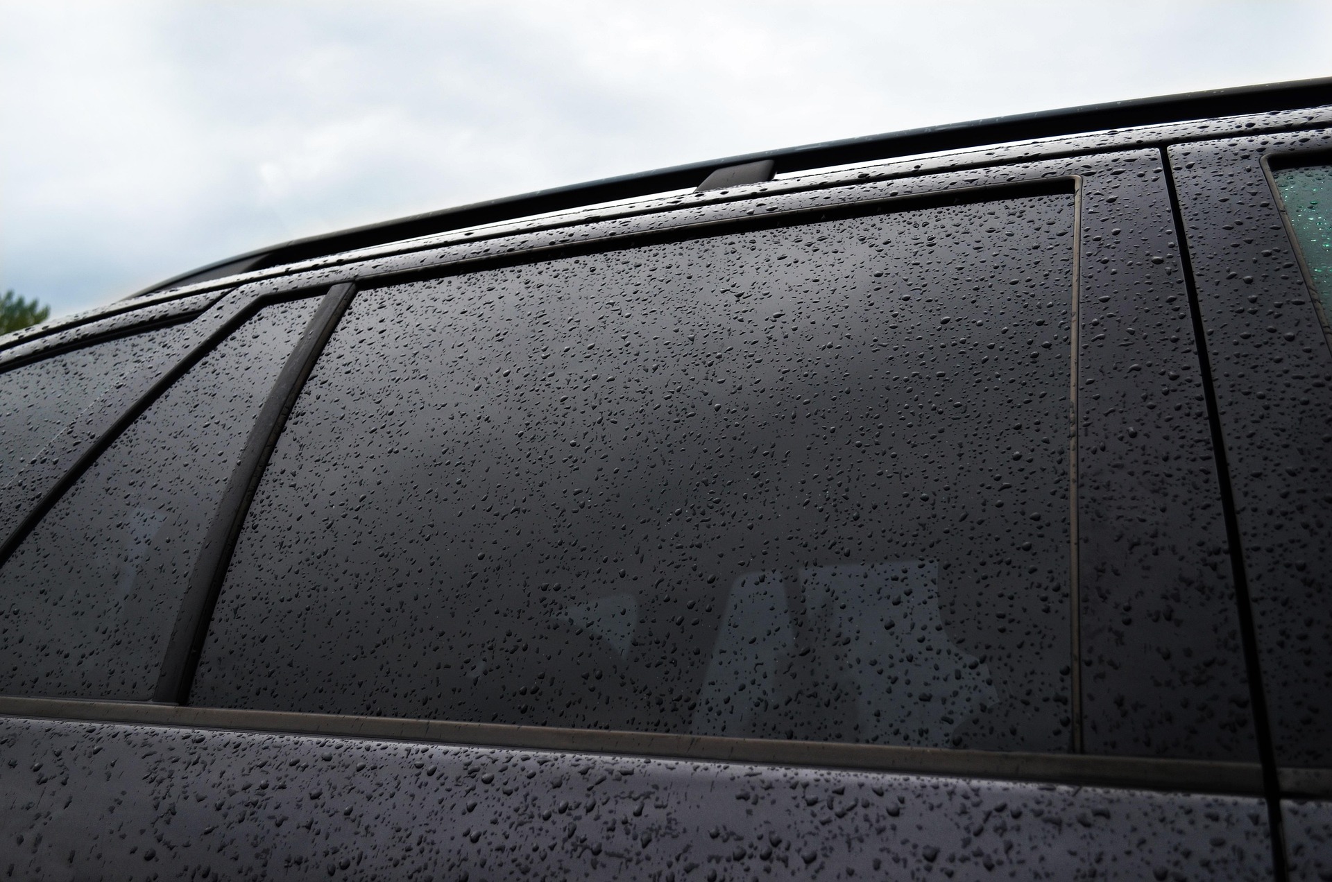Dark tinted windows with rain